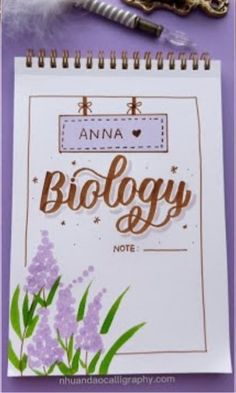 an open notebook with writing on it next to a pair of scissors and some flowers