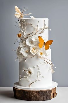 a white wedding cake decorated with flowers and butterflies