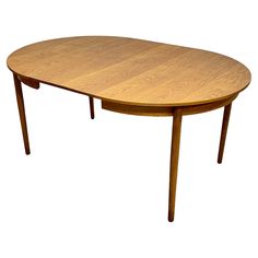 an oval wooden table with two leaves on the top and one leaf at the bottom