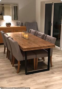 a dining room table and chairs with candles on it