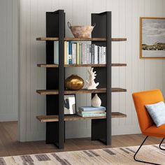 an orange chair sitting in front of a bookshelf