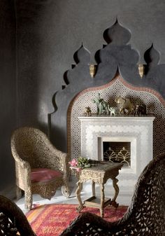 a living room filled with furniture and a fire place next to a wall mounted fireplace