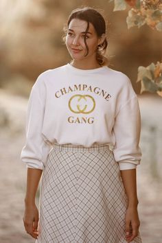 Champagne Gang Sweatshirts with gold glitter font 🍾 Bulk orders welcome 💗 These beautiful, custom shirts come in 2 different styles. Crew or boat neck, boat neck is raw seem off the shoulder look and created by Clarita herself 💗 These shirts are great quality 80% Cotton 20% Polyester. The font is in gold glitter. Please message me if you are wanting a different color font. We can change at no extra cost 😊 These are available in black gray and white. Midweight fabric, soft cotton face with fl Classy Bachelorette Party, Wifey Sweatshirt, Bride Sweatshirt, Fun Shirts, Books Crafts, Off Shoulder Sweater, Sorority Shirts, Fall Sweatshirt, Oversized Hoodie