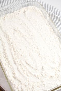 a glass bowl filled with white powder on top of a table