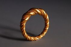 24k solid gold twist ring made in the tradition of Viking rings. The twist and braid styles of rings were made very soulfully throughout Viking history. Some were Romanized, some became lost.  Many are just plain beautiful to look at, in pictures, but never available for sale. This Classical Wreath Twist is one such lost ring; we looked at various museum versions so much we decided to make one available. It is not difficult to make a twist ring, but it is a challenge to make this ring both robust and surpass museum predecessors. The bands in this ring thicken at the centre, hand-braided as if gold was easy to braid. The ring is solid and feels solid, suitable for one looking for a ring or band whose memorable beauty is striking from its archetypal form. This ring will wear with any jewelry Viking Style Handmade Gold Jewelry, Handmade Viking Style Ring As Gift, Handmade Viking Style Ring For Gift, Handmade Viking Style Ring Jewelry, Adjustable Viking Jewelry Ring, Ring Wreath, Twisted Band Ring, Viking Ring, Twisted Band