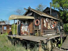 an old wooden house sitting on top of a train track