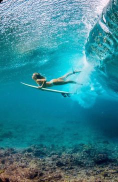 a person on a surfboard in the water with a wave coming up behind them