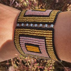 a close up of a person's arm wearing a bracelet with beads on it