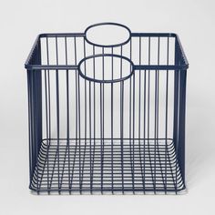 a blue wire basket with two circles on the top and bottom, sitting in front of a white background