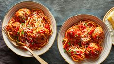 two bowls filled with spaghetti and meatballs