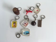 several different keychains are arranged on a white surface