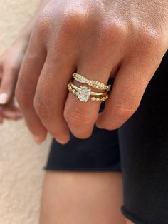 a close up of a person's hand wearing two rings