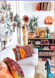 a living room filled with lots of furniture and decor on top of a white couch