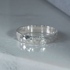 a silver ring sitting on top of a white counter