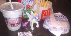 mcdonald's fries, milkshake and other items are on the table next to each other