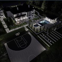 an aerial view of a basketball court at night with lights on and in the ground