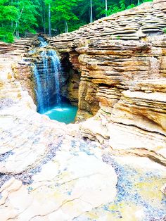 a small waterfall in the middle of some rocks