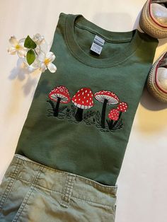 A Perfect Gift For Mushroom Lovers! A T-Shirt With Wild Mushrooms Embroidered On It. Our Wild Mushroom Shirt Is a Great Gift For Anyone Who Loves Mushrooms. Mushroom Embroidered T-Shirt | Vintage Shirt | Botanical Shirt | Mushroom Shirt | Cottage core | mushroom lover | Mycology Tee | T-Shirt Mushroom Shirt Design, Cottage Core Mushroom, Mushroom Shirt, Wild Mushroom, Botanical Shirt, Embroidery On Clothes, Embroidered Tee, Painted Denim, Embroidered Crewneck