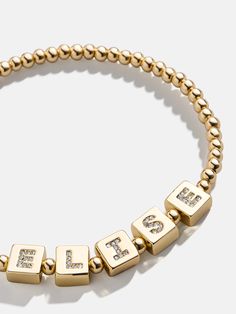 Let your style shine with our Golden Custom Pisa Bracelet. Customize it with your name or a special phrase, and rock this brass golden pisa bracelet with letters in shimmering glass stones. This custom bracelet easily stretches to fit anyone's wrist and adds a pop of personality to your everyday wrist stack. Name Friendship Bracelets, Bracelet With Letters, Wrist Stack, Gold Bracelets Stacked, Last Day To Order, Wrist Stacks, Early Black Friday, Custom Bracelet, Fun Jewelry