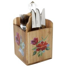 a set of knives and forks in a wooden holder with floral designs on it's sides