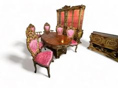 an old fashioned dining room set with pink velvet upholstered chairs