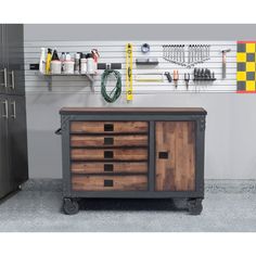 a tool cabinet sitting in front of a garage wall