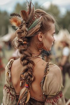 Adorned with feathers and wooden beads, this messy fishtail braid embodies the festival wild child look, blending carefree vibes with bohemian elegance. Hairstyles With Feathers, Hair Beads Braids Boho, Feathers In Hair, Messy Fishtail Braids, Messy Fishtail, Feather Accessories, Hair Photoshoot, Hair Feathers, Makeup Glam