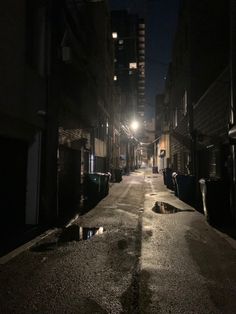 an empty street at night with no one on it or people walking down the sidewalk