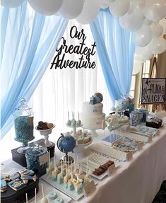 the dessert table is decorated with blue and white balloons