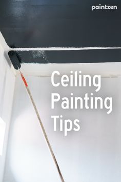 a painting brush is in the corner of a room with white walls and black paint