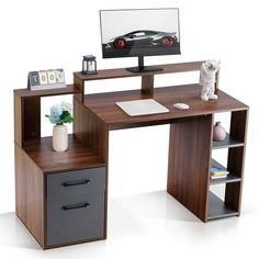 a computer desk with a monitor, keyboard and mouse next to it on a white background