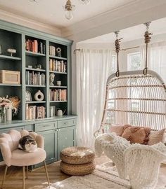 a living room with a hammock chair and bookshelf