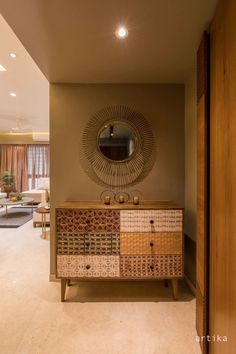 a living room with a dresser and mirror in the corner, along with other furniture