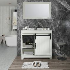 a white sink sitting under a mirror next to a bath tub in a room with marble walls