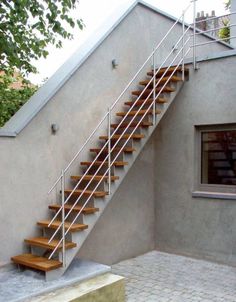 a set of stairs leading up to the top floor of a house with glass doors