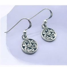 Discover the timeless elegance of our 925 Sterling Silver Triskelion Hook Earrings, an exquisite addition to any jewelry collection. Crafted with meticulous attention to detail, these earrings feature the ancient triskelion symbol, representing motion, progress, and the cycle of life. Made from high-quality 925 sterling silver, each piece is stamped with the 925 hallmark, ensuring its authenticity and superior craftsmanship. Measuring 7/16 inches in width and 1 1/32 inches in length, these earri Classic Sterling Silver Earrings, Classic Hallmarked Sterling Silver Earrings, Round Engraved Sterling Silver Earrings, Engraved Sterling Silver Round Earrings, Engraved Sterling Silver Earrings, Symbolic Sterling Silver Pierced Earrings, Symbolic Sterling Silver Jewelry For Formal Occasions, Classic Engraved Sterling Silver Earrings, Classic Engraved Silver Earrings