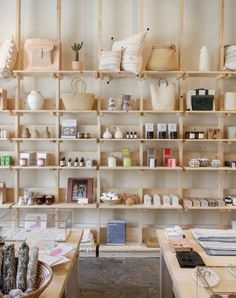 a room with shelves filled with lots of different types of items and baskets on them