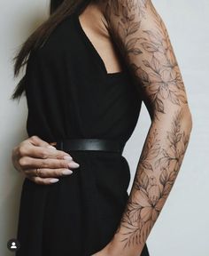 a woman with tattoos on her arms and arm