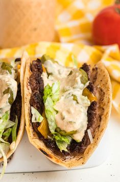 two tacos sitting on top of a white plate