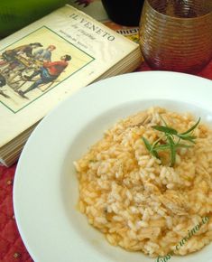 a white plate topped with rice next to a book