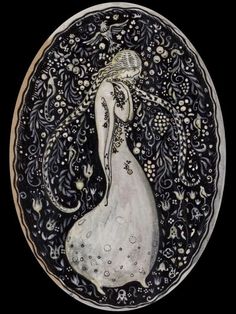 a white and black plate with an image of a woman in a dress on it