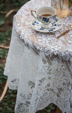 a table topped with a cup and saucer