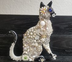 a cat made out of beads and other things