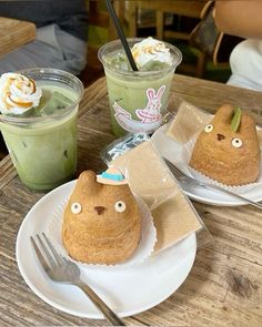 two desserts are sitting on plates with forks and spoons in front of them