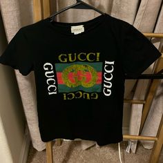 Gucci Size 10 Gucci Designer Black T-shirt, Designer Gucci Black T-shirt, Gucci Black T-shirt With Logo Print, Black Gucci Tops With Letter Print, Gucci Black Short Sleeve Tops, Black Gucci Short Sleeve T-shirt, Gucci Black Tops With Letter Print, Gucci Fitted Casual Top, Casual Fitted Gucci Tops