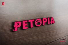 the word petopia written in pink on a stainless steel surface