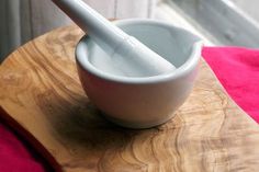 a wooden table with a bowl and spoon on it