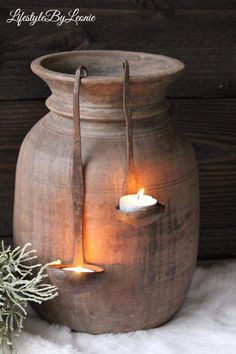 a candle is lit in a clay pot