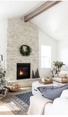 a living room with a christmas tree in the corner and presents on the fireplace mantel