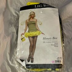 the package is wrapped in plastic and has a woman dressed as a bee on it